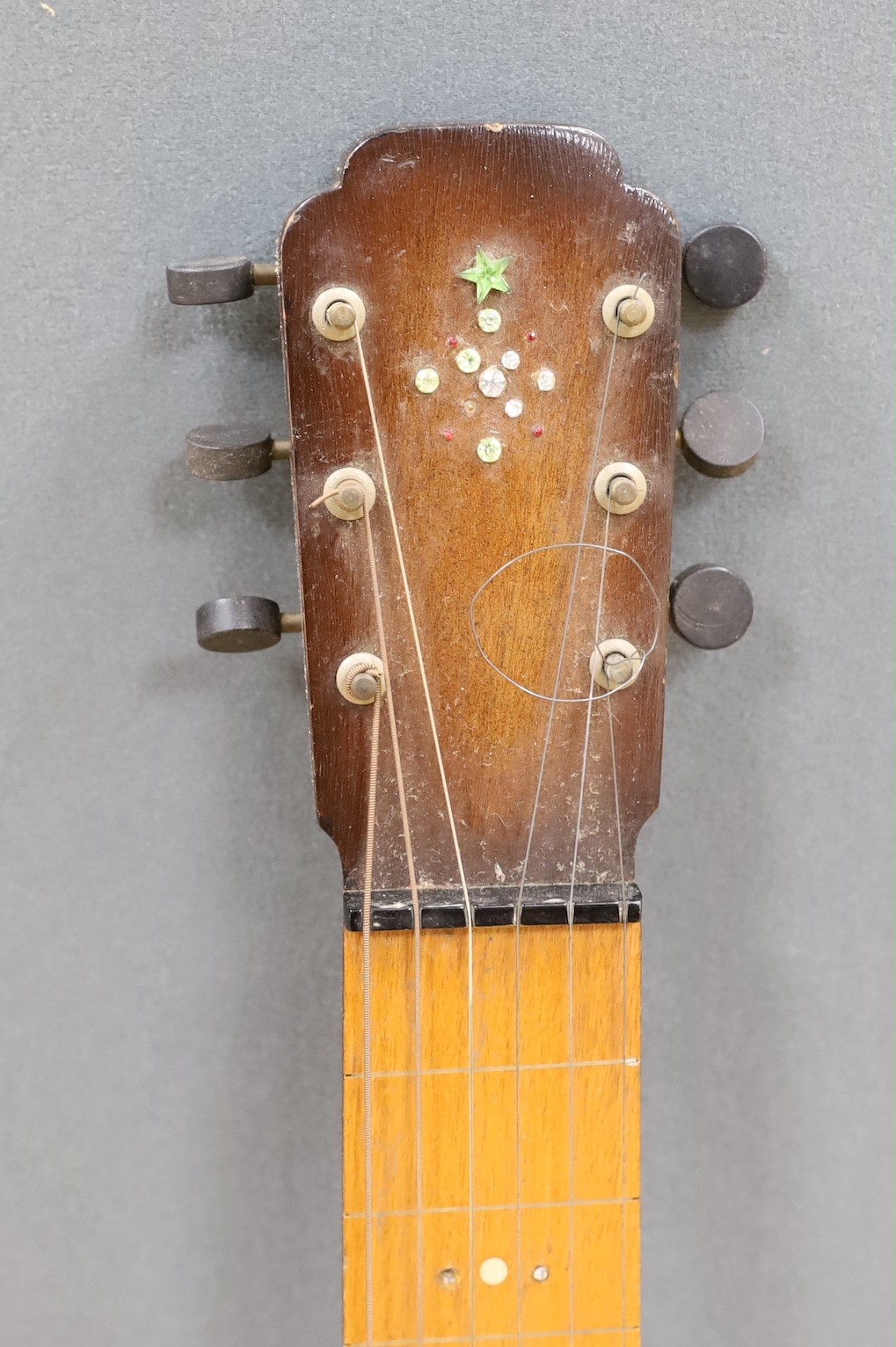A steel guitar, the case, inscribed Haiwaians, 83cms high